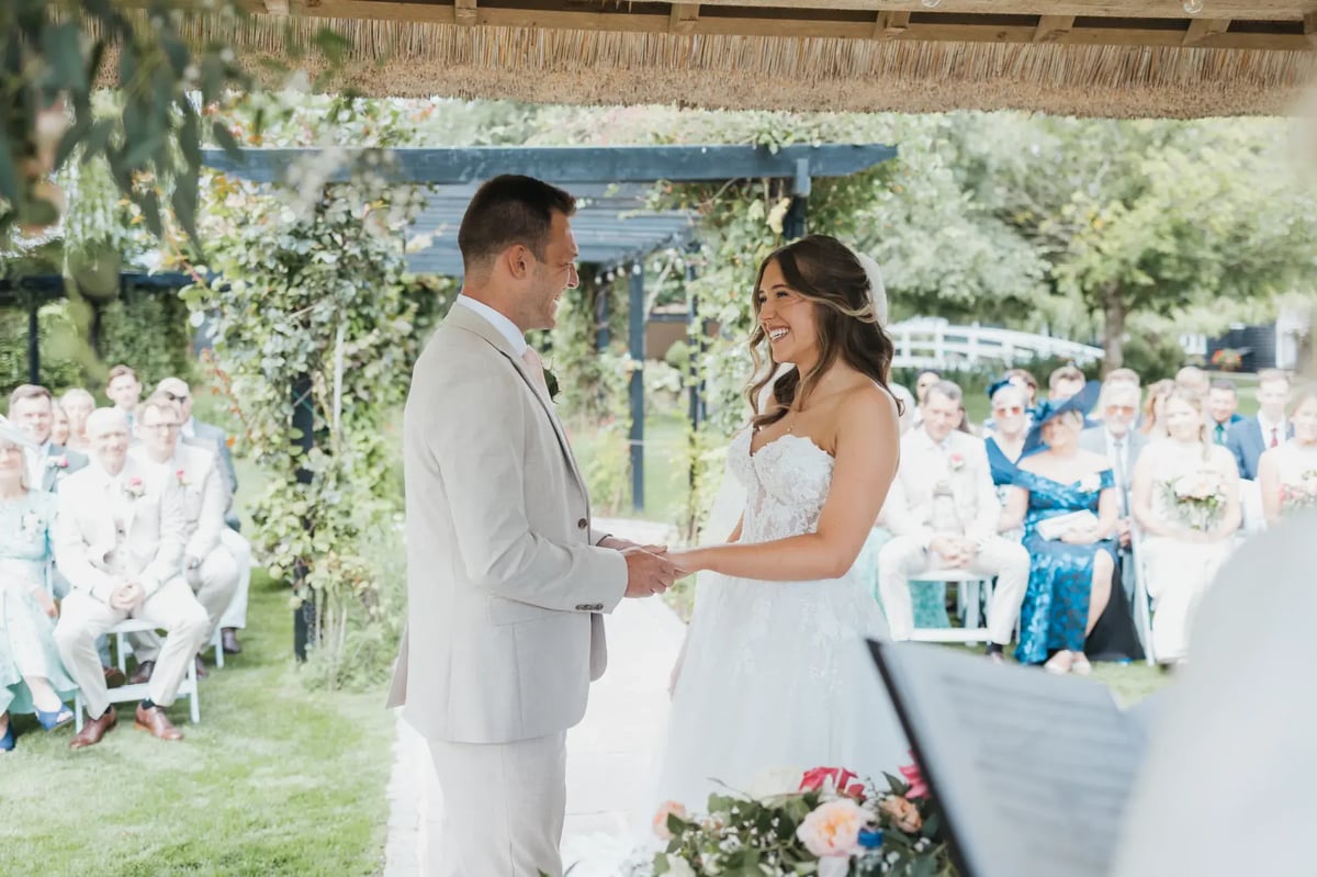 Couple smiling under wedding Gazebo at High House