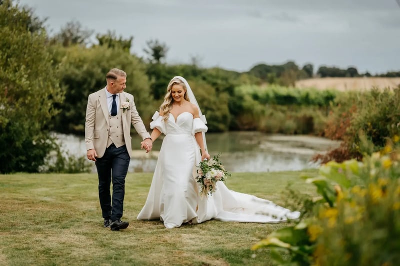 Bride and groom walking through the secret garden at High House