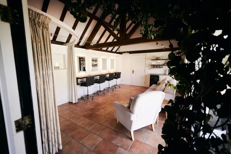 Dressing area with seating and mirrors at High House