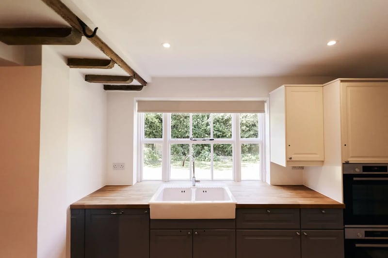 Kitchen area with sink and large window in accommodation at High House