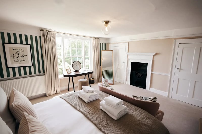 Bedroom with large window and fireplace in accommodation at High House