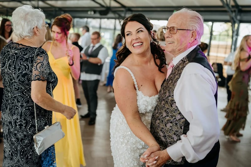 Bride dancing with a guest in the Orangery at High House