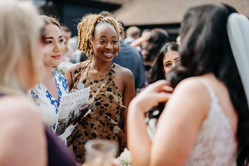 Guests laughing and talking to bride at High House