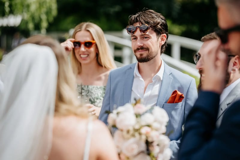 Wedding guests standing outside with the bride at High House