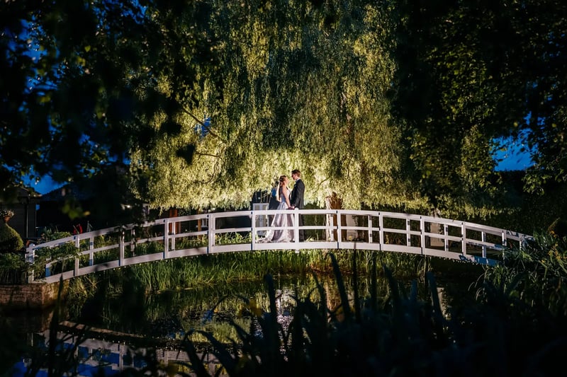 Couple posing at night on bridge at High House