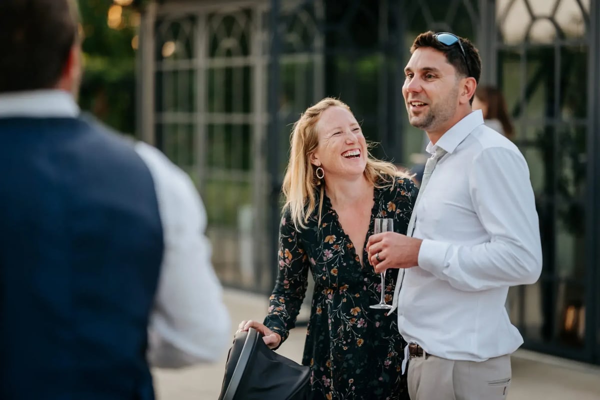 Two guests laughing outside the Orangery at High House
