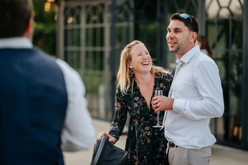 Two guests laughing outside the Orangery at High House