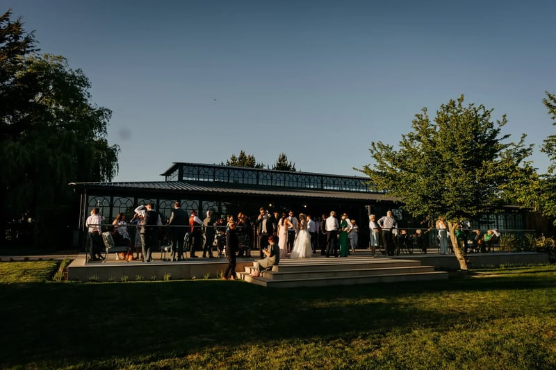 Wedding guests talking outside of the Orangery at High House