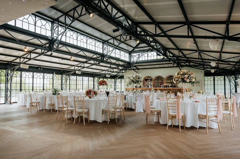 Tables dressed with napkins and flowers in the Orangery at High House