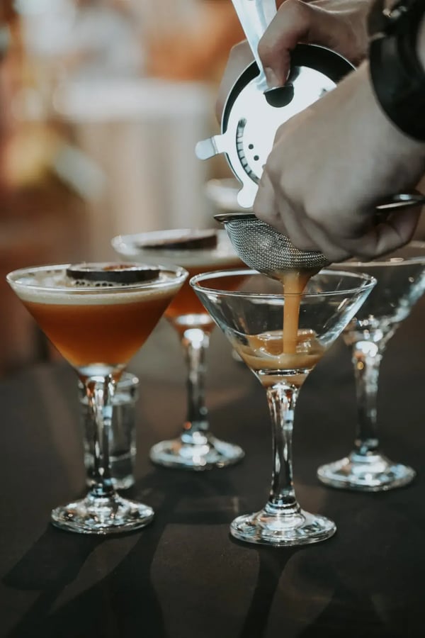 Bar tender pouring martinis at High House