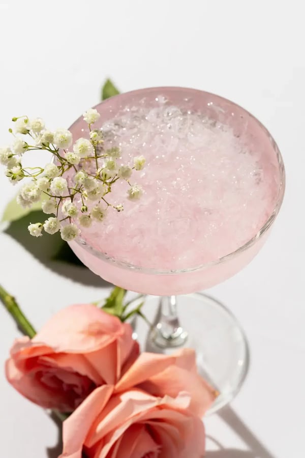 Pink drink in martini glass with flowers at High House