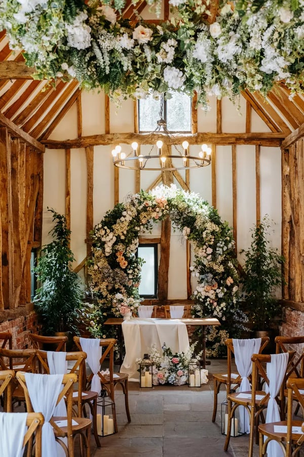 Wedding barn with flowers and flower arch at High House